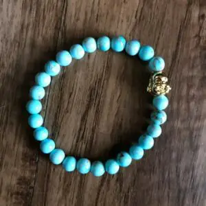 Blue turquoise beaded bracelet with gold charm.