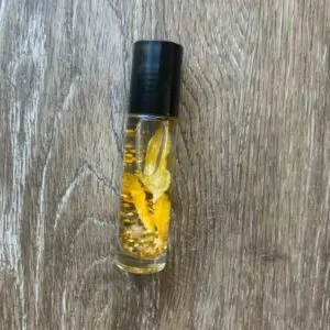Gold glitter and flower oil roller bottle.