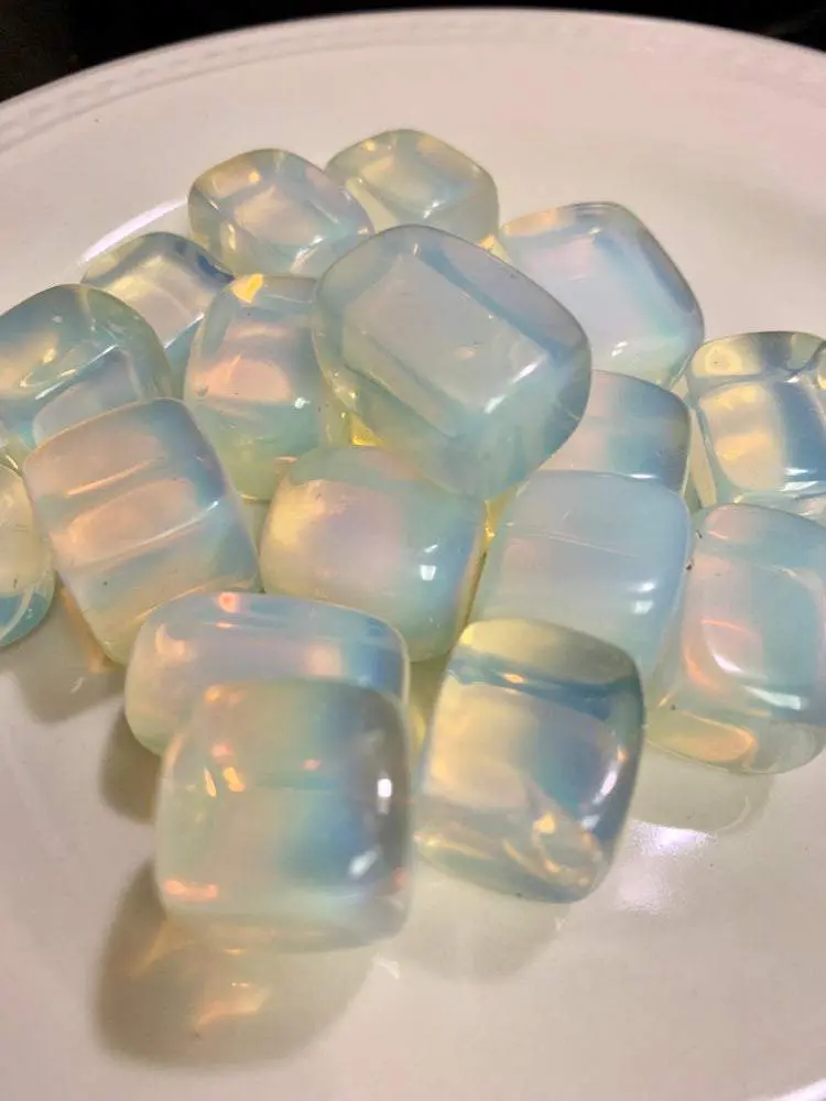 A pile of iridescent opal stones. A pile of iridescent opal stones.