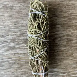 White sage smudge stick on wood.