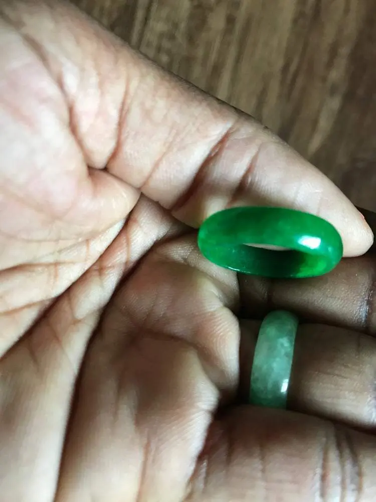 Two green jade rings on a hand. Two green jade rings on a hand.