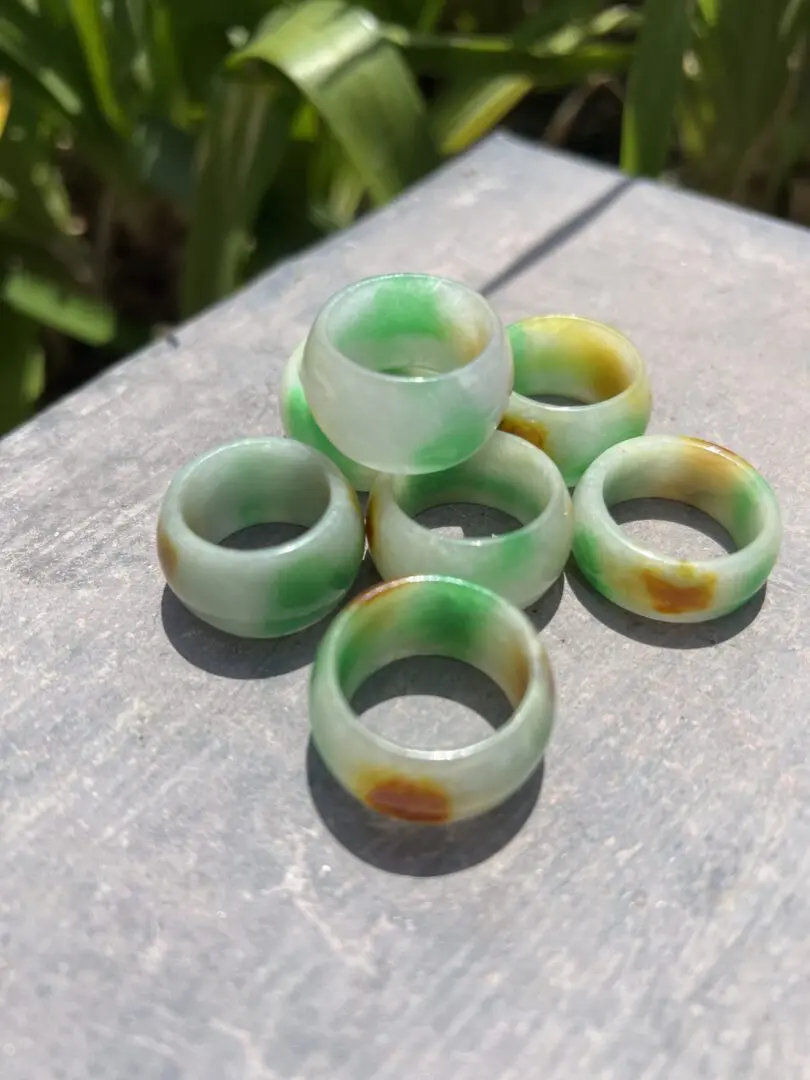 A group of six green and yellow rings on top of a table. A group of six green and yellow rings on top of a table.