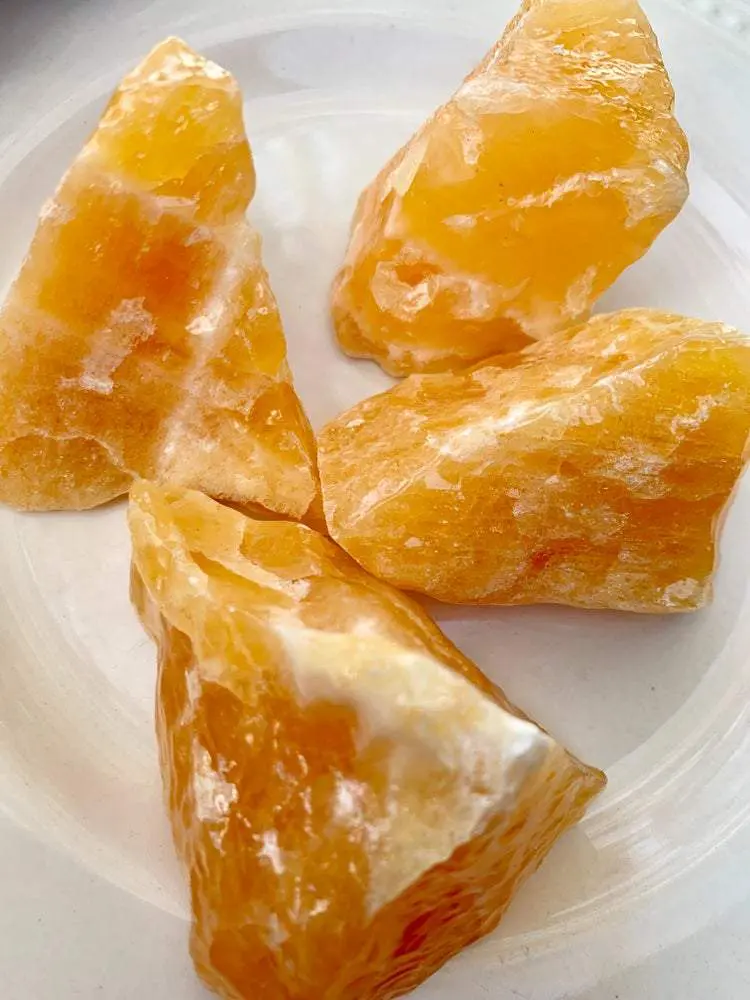 Four orange calcite crystal chunks. Four orange calcite crystal chunks.