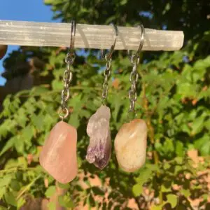 Three crystal stone keychains on display.