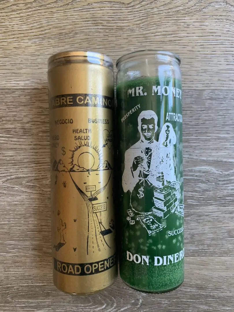 Two green and gold money candles. Two green and gold money candles.