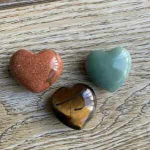 Three heart shaped gemstone crystals.