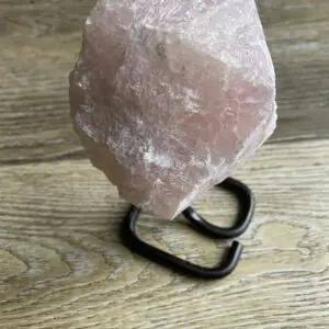 Pink crystal on a black stand.