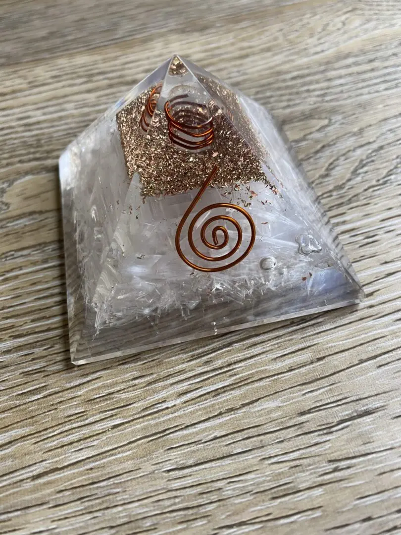 Clear crystal pyramid with copper wire. Clear crystal pyramid with copper wire.
