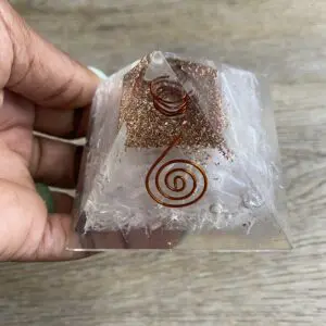 Clear crystal pyramid with copper wire.