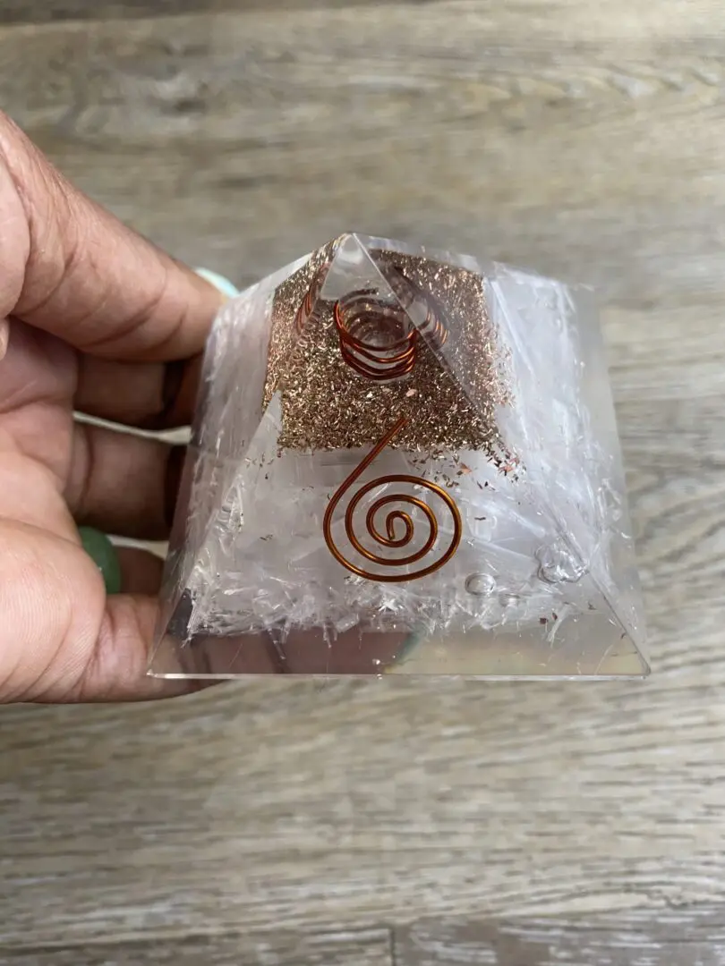 Clear crystal pyramid with copper wire. Clear crystal pyramid with copper wire.