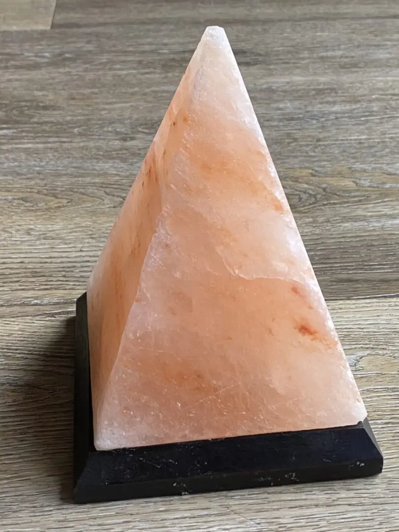 Pink Himalayan salt lamp on wooden floor. Pink Himalayan salt lamp on wooden floor.