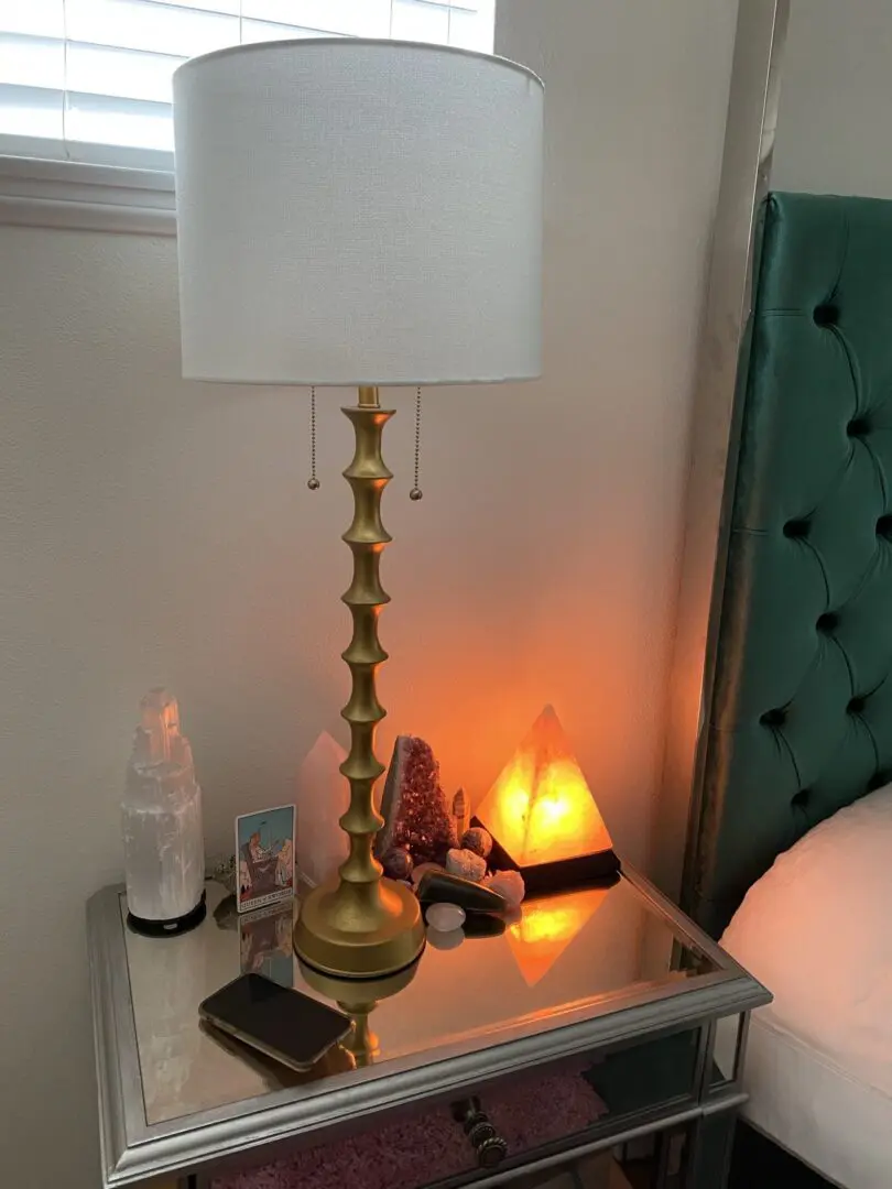 Gold lamp on a mirrored nightstand. Gold lamp on a mirrored nightstand.