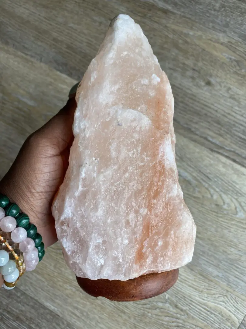 Pink Himalayan salt lamp on wooden base. Pink Himalayan salt lamp on wooden base.