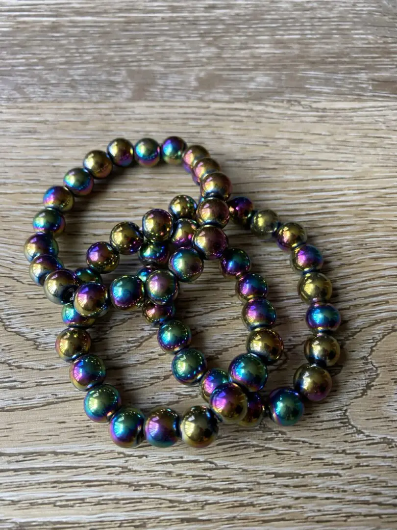 Rainbow iridescent beaded bracelet on wood. Rainbow iridescent beaded bracelet on wood.