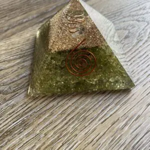Green crystal pyramid with copper coil.