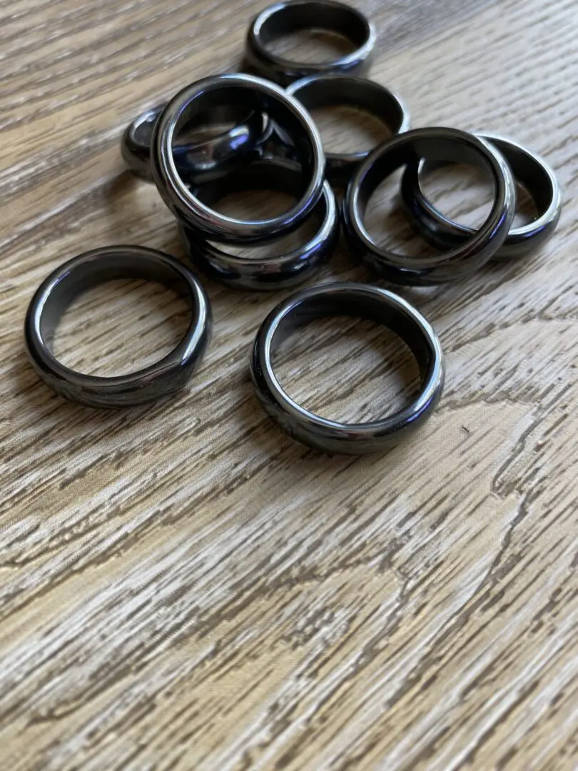 Black hematite rings on wood table. Black hematite rings on wood table.