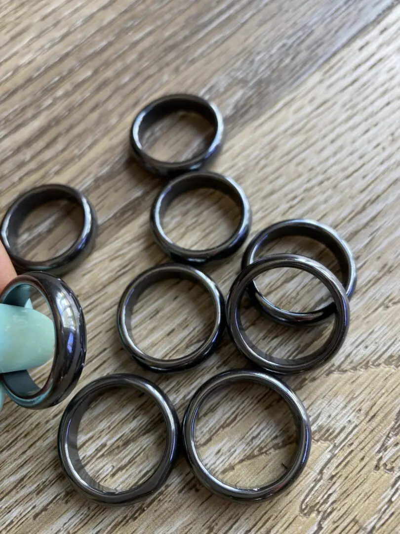 Black hematite rings on wood background. Black hematite rings on wood background.