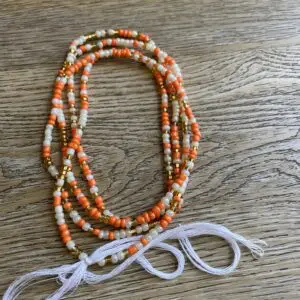 Orange, white, and gold beaded necklace.