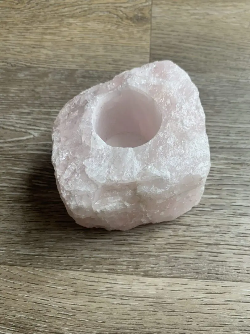 Pink crystal candle holder on wood. Pink crystal candle holder on wood.