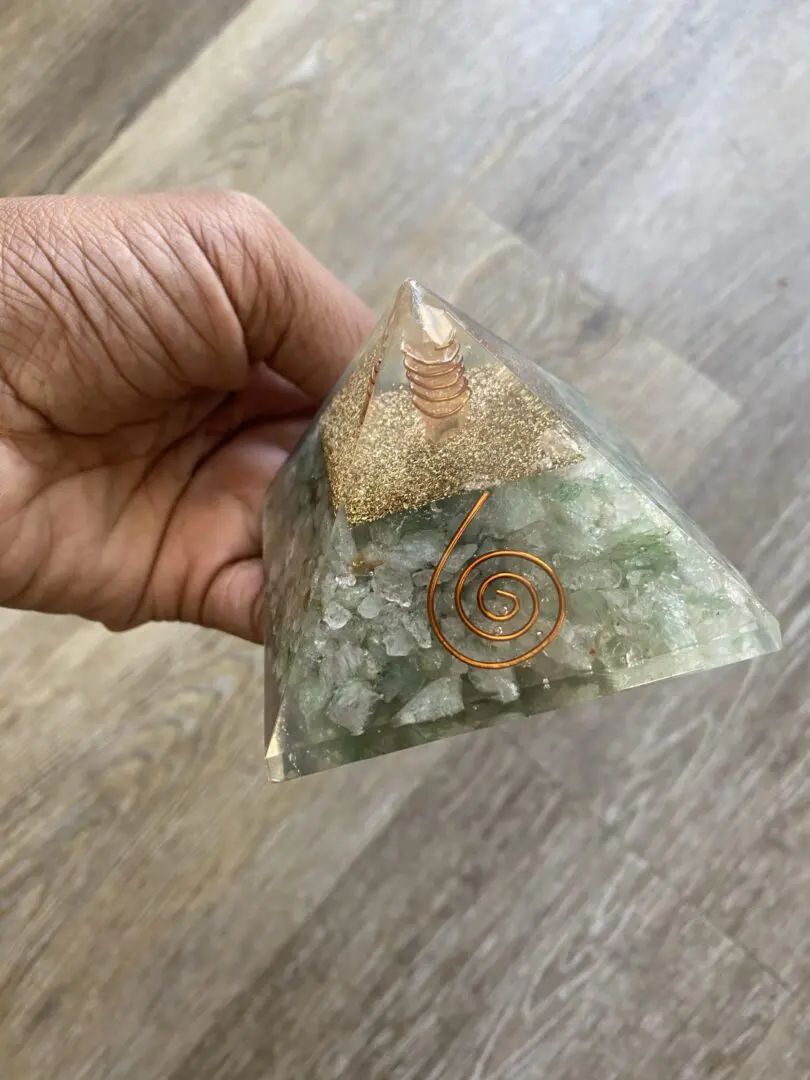Green crystal pyramid with copper wire. Green crystal pyramid with copper wire.