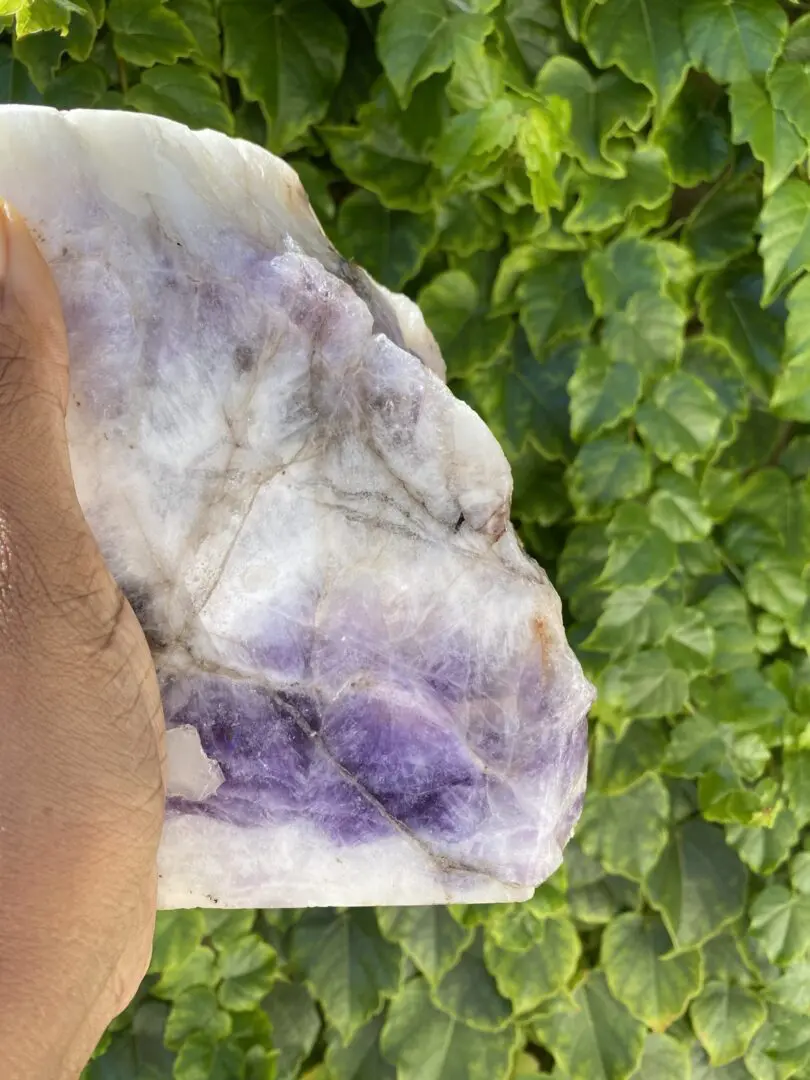 Hand holding a large amethyst crystal. Hand holding a large amethyst crystal.