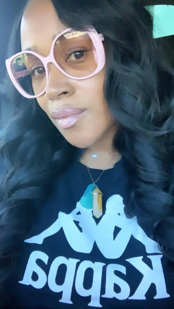 Woman with pink glasses wearing a Kappa shirt. Woman with pink glasses wearing a Kappa shirt.