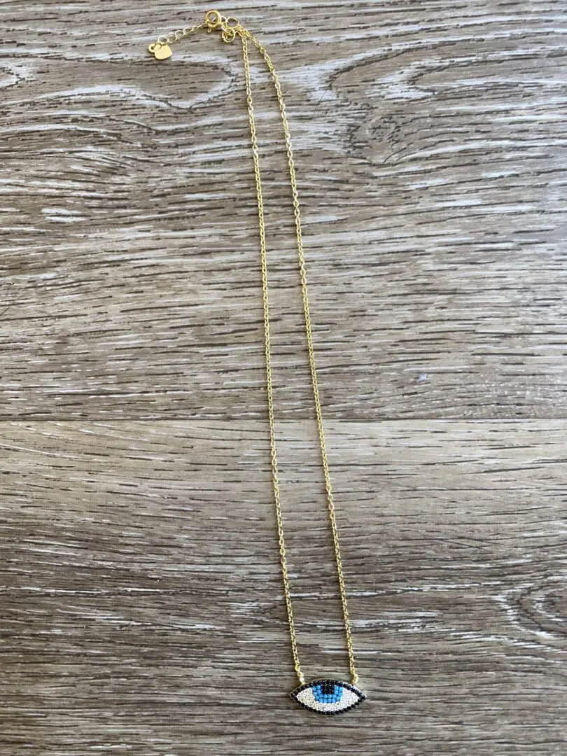 Gold chain with blue evil eye pendant. Gold chain with blue evil eye pendant.