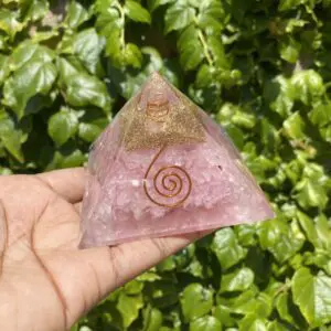 Pink crystal pyramid with gold and wire.