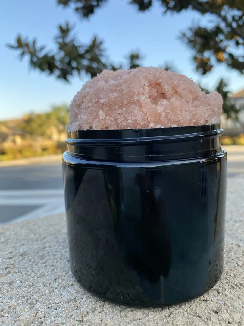 Pink salt scrub in a black jar. Pink salt scrub in a black jar.