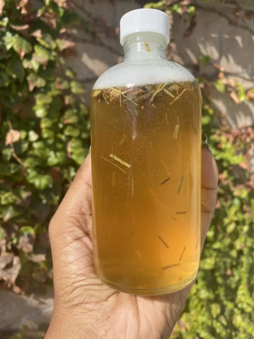 Glass bottle of herbal infused oil. Glass bottle of herbal infused oil.