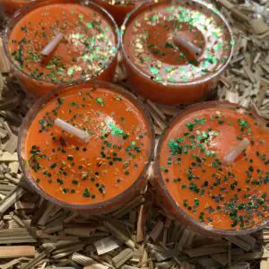 Orange scented candles with glitter.