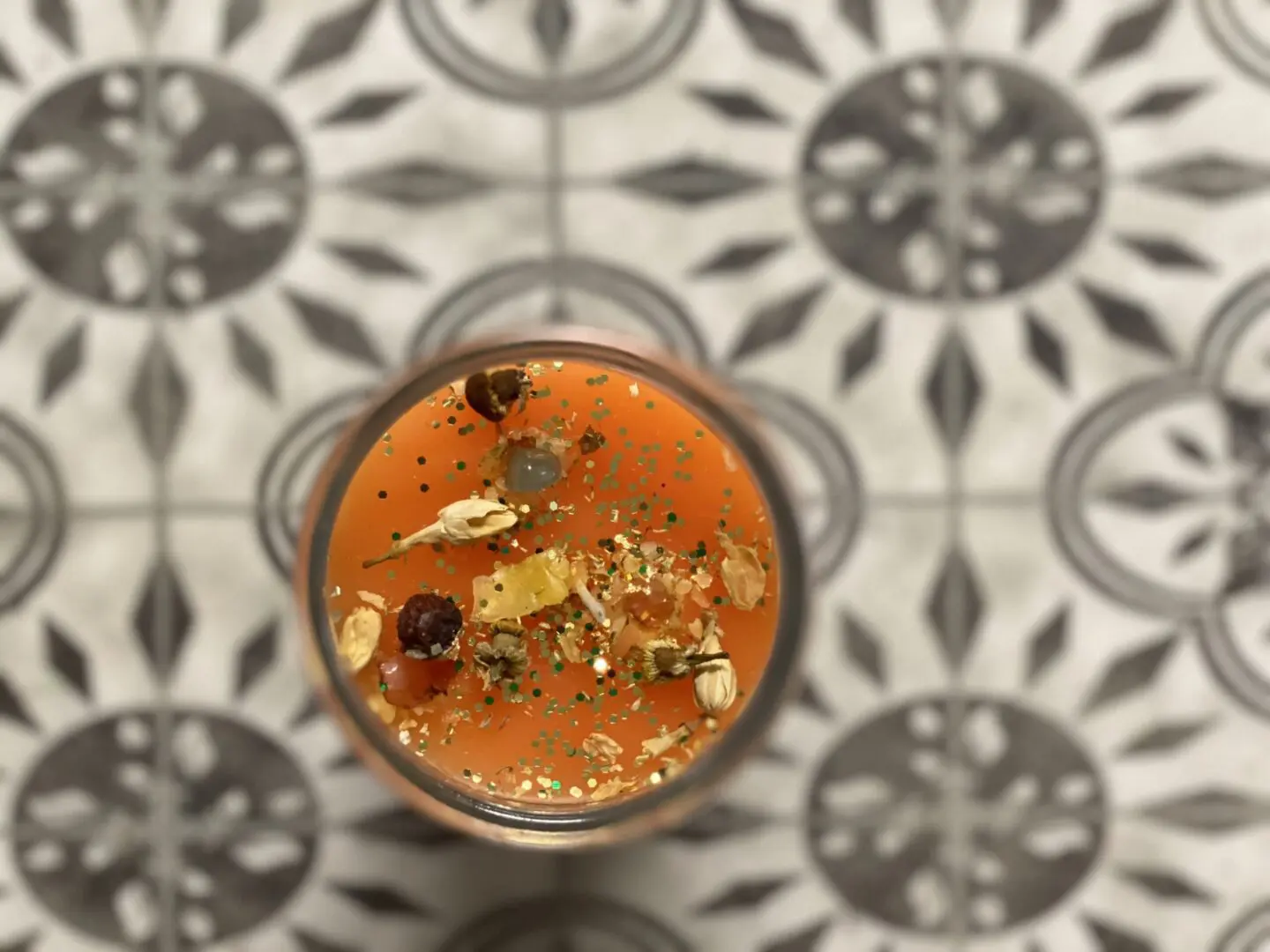 A glass of orange juice on the floor A glass of orange juice on the floor