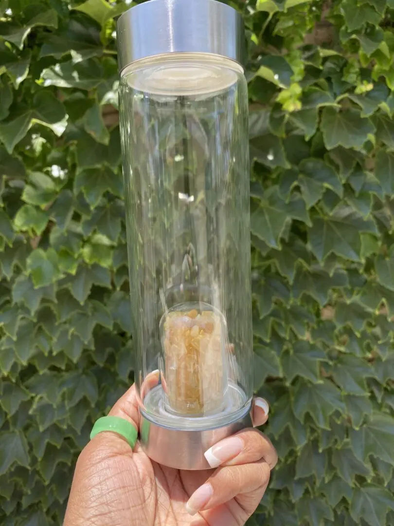 A person holding a glass tube with liquid inside. A person holding a glass tube with liquid inside.