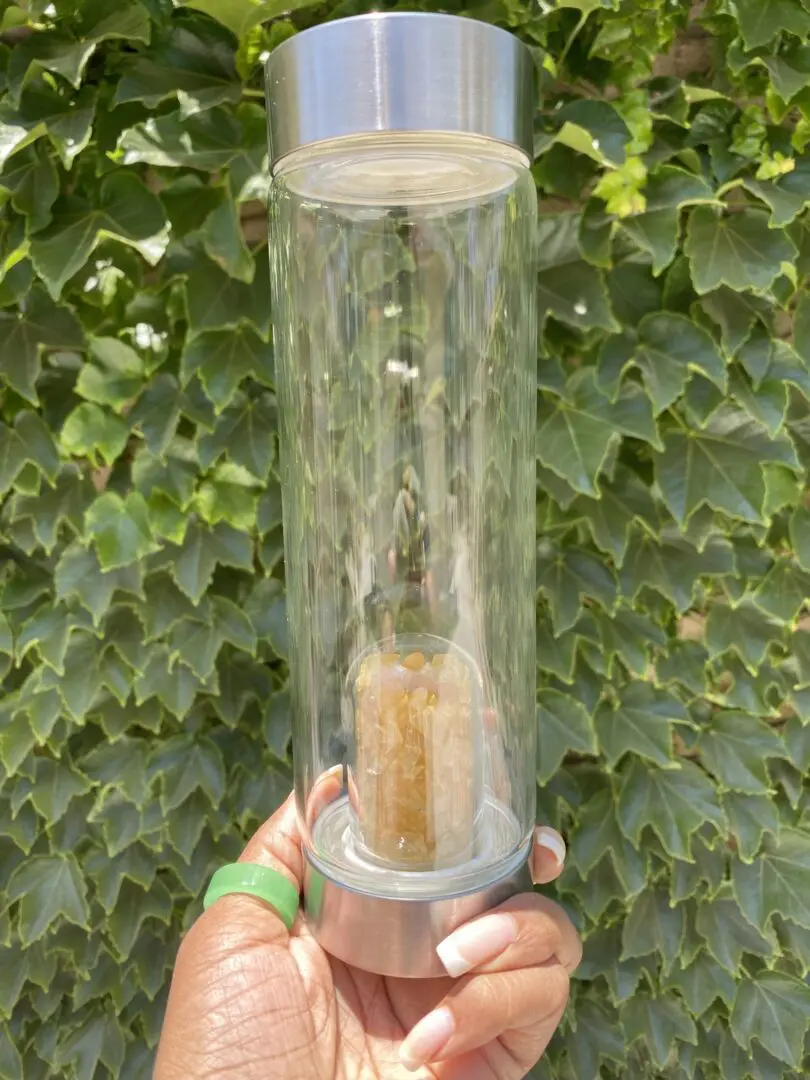 A person holding up a glass tube with something inside. A person holding up a glass tube with something inside.