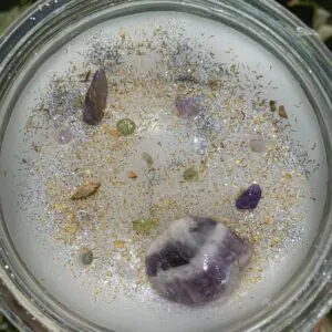 A glass of water with some kind of substance on it