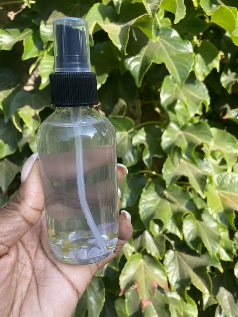 A person holding a spray bottle in their hand. A person holding a spray bottle in their hand.