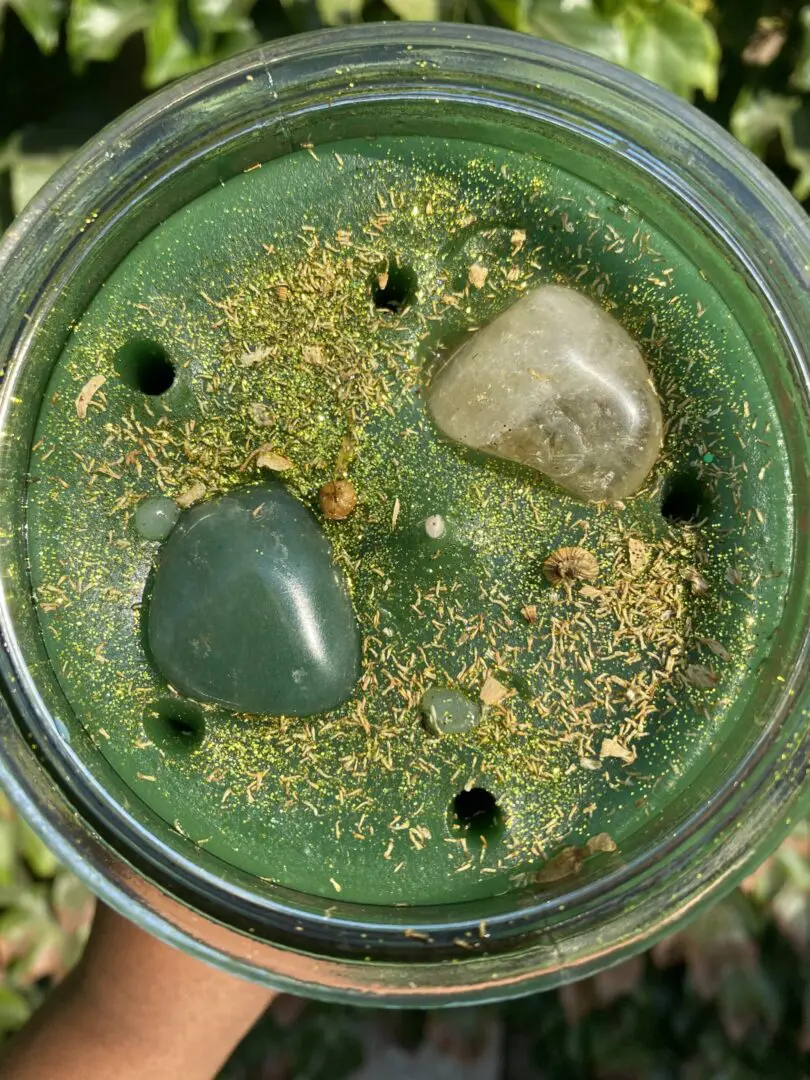 A cup of green liquid with rocks inside. A cup of green liquid with rocks inside.