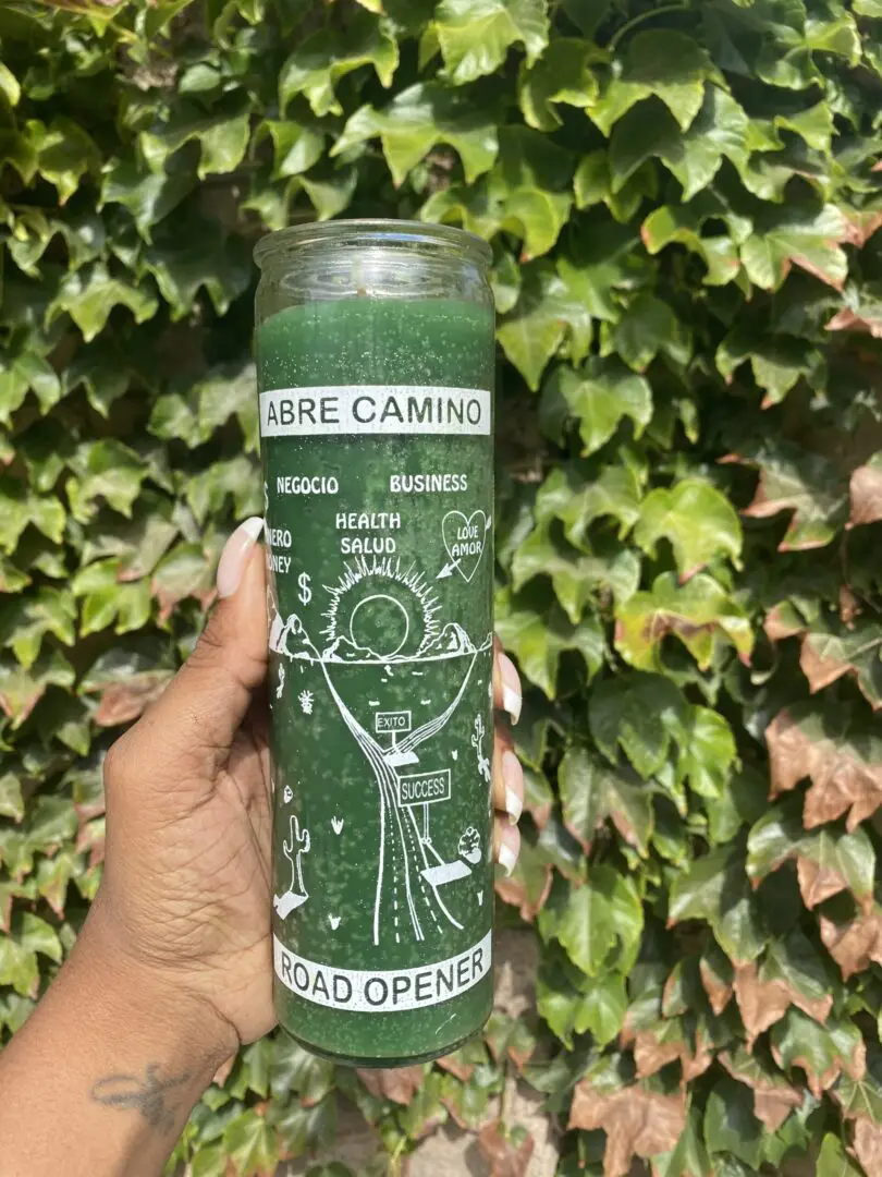 A person holding onto a candle with the words " camino " written on it. A person holding onto a candle with the words " camino " written on it.