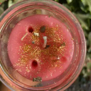 A candle that has some gold on it.