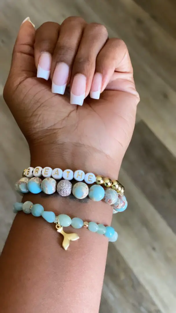 A hand with french manicure and a bracelet A hand with french manicure and a bracelet