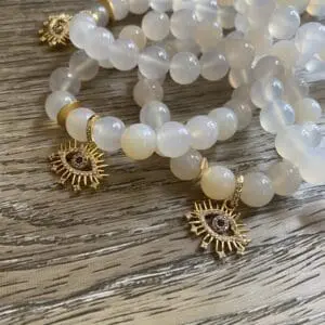 A close up of bracelets on top of a wooden table.