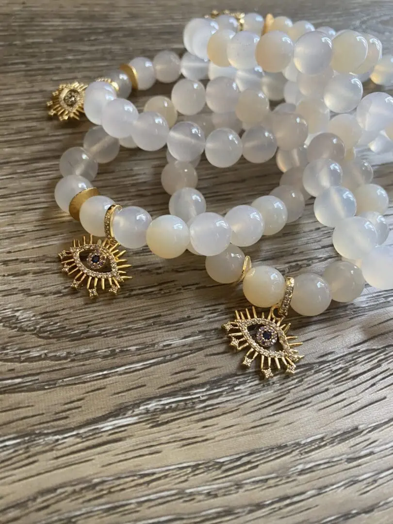 A close up of bracelets on top of a wooden table. A close up of bracelets on top of a wooden table.
