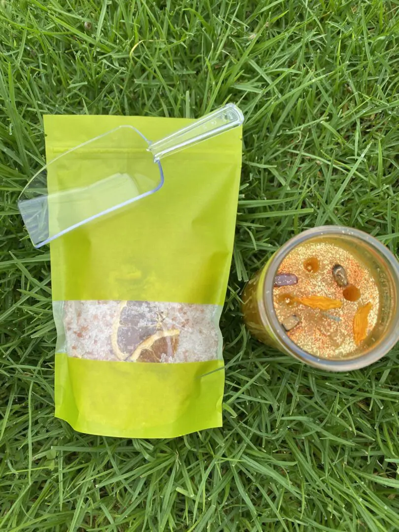 A cup and bag of food on the grass. A cup and bag of food on the grass.