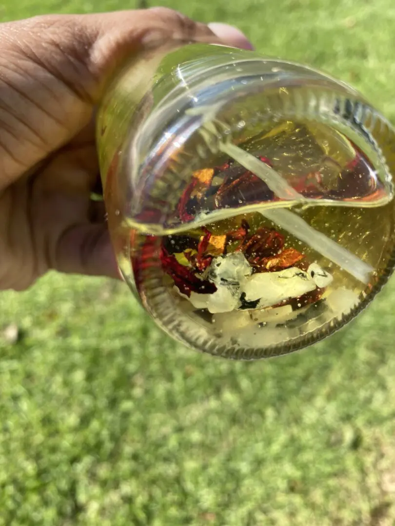 A person holding a glass filled with food. A person holding a glass filled with food.