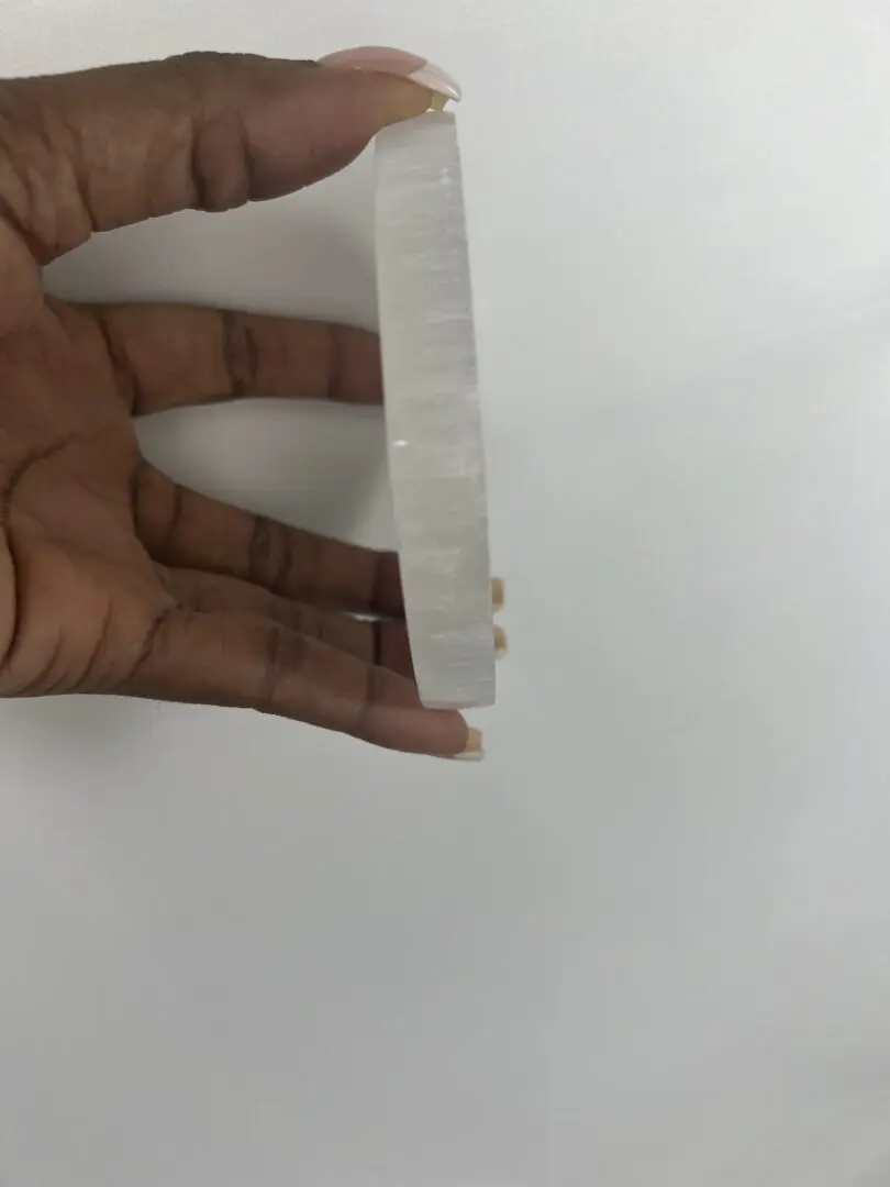A hand holding a piece of paper in front of the camera. A hand holding a piece of paper in front of the camera.