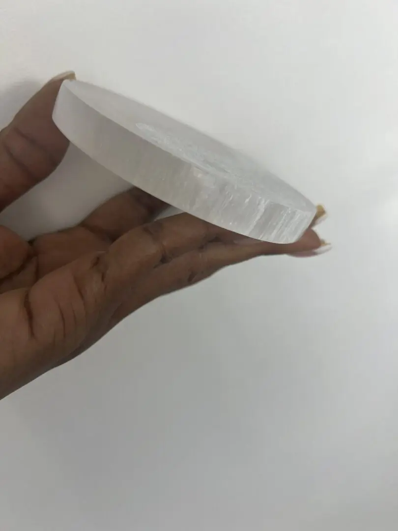 A person holding onto a white paper plate A person holding onto a white paper plate