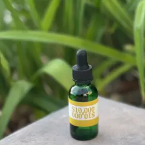 A bottle of cbd oil sitting on top of a table.