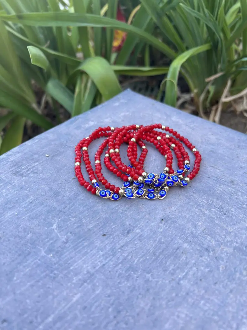 A close up of a stack of bracelets on top of a table. A close up of a stack of bracelets on top of a table.