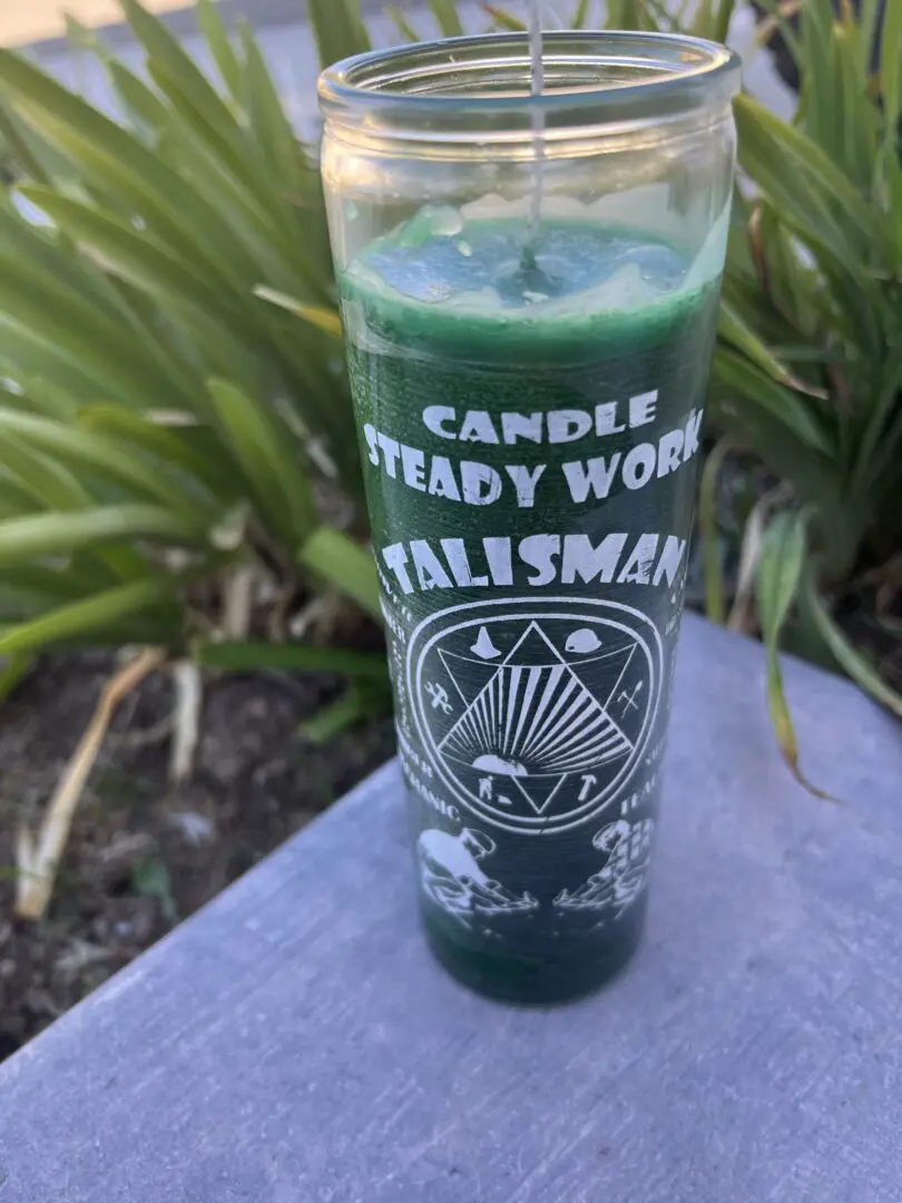 A candle that is sitting on the ground. A candle that is sitting on the ground.