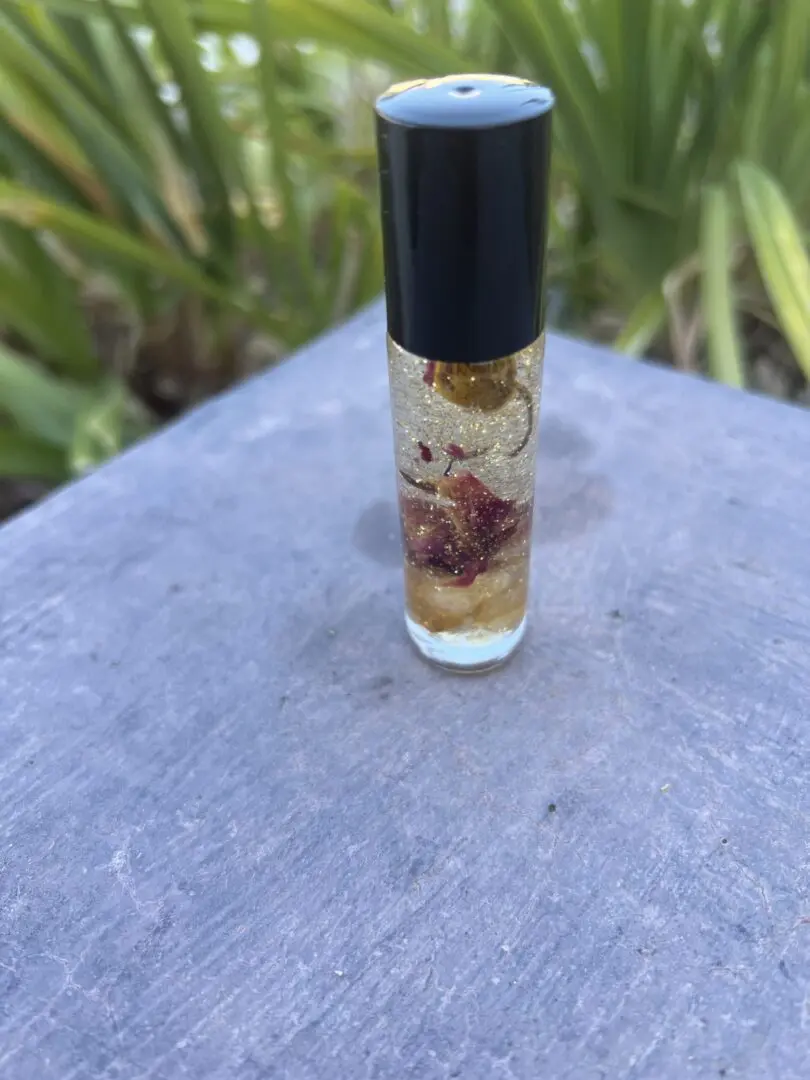 A bottle of perfume sitting on top of a table. A bottle of perfume sitting on top of a table.
